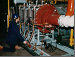 Worker examining steam boiler